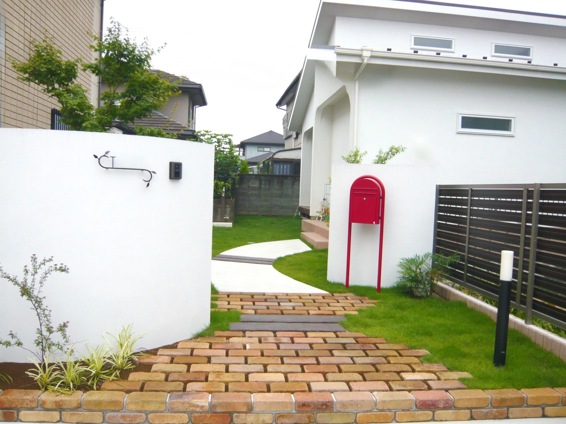 熊谷市 2枚の塗壁とレンガ敷きのアプローチが印象的なナチュラル外構